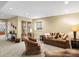Relaxing living area with a plush brown sofa, stylish shelving and decor at 12431 Red Fox Way, Broomfield, CO 80021