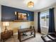 Home office with a rustic desk, two-tone walls, a comfortable chair, and natural light from the window at 12431 Red Fox Way, Broomfield, CO 80021