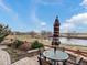 Outdoor patio seating area overlooking a scenic pond and expansive landscape at 12431 Red Fox Way, Broomfield, CO 80021