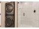 Modern bathroom featuring a sleek, stackable washer and dryer and shower at 2120 N Downing St # 216, Denver, CO 80205
