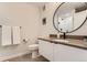Well-lit bathroom featuring a round mirror, modern vanity, and a clean, minimalist design at 2120 N Downing St # 216, Denver, CO 80205