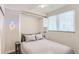 This bedroom contains a Murphy bed, light wood-look floors, and a ceiling fan at 2120 N Downing St # 216, Denver, CO 80205