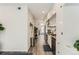 Long, galley-style kitchen with white cabinets and stainless steel appliances at 2120 N Downing St # 216, Denver, CO 80205