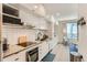 A modern kitchen with sleek white cabinetry, stainless steel appliances, and subway tile backsplash at 2120 N Downing St # 216, Denver, CO 80205