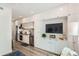 A modern kitchen with sleek white cabinets, stainless steel appliances, and an integrated media center at 2120 N Downing St # 216, Denver, CO 80205