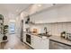 Modern kitchen featuring white cabinets, stainless steel appliances, and a subway tile backsplash at 2120 N Downing St # 216, Denver, CO 80205