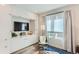 Bright living room with built-in cabinets, large window, and a comfortable chair with a fur throw at 2120 N Downing St # 216, Denver, CO 80205