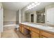 Well lit bathroom with double sinks, shower, and bath at 9816 W Freiburg Dr # A, Littleton, CO 80127