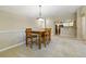 Dining area features neutral carpet, ample space, and flows into the kitchen area at 9816 W Freiburg Dr # A, Littleton, CO 80127