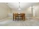 View of dining area with modern lighting and neutral carpeting in a well lit, neutral-toned home at 9816 W Freiburg Dr # A, Littleton, CO 80127