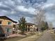 View of multi-story condos with stone accents, balconies, and walking path at 9816 W Freiburg Dr # A, Littleton, CO 80127