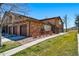 Beautiful two-story townhouse with brick and siding exterior and attached garages on a sunny day at 9816 W Freiburg Dr # A, Littleton, CO 80127