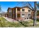 Two-story condo with stone and siding exterior, with well-maintained landscaping at 9816 W Freiburg Dr # A, Littleton, CO 80127
