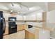 Well-lit kitchen features wood floors, track lighting, and lots of counter space for cooking at 9816 W Freiburg Dr # A, Littleton, CO 80127