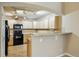 Kitchen boasts ample cabinetry, modern appliances, and a convenient breakfast bar at 9816 W Freiburg Dr # A, Littleton, CO 80127