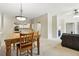 Open-concept dining and living room areas feature neutral carpet, lighting, and plenty of space at 9816 W Freiburg Dr # A, Littleton, CO 80127