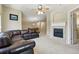 Living room with fireplace and an open floor plan featuring a dining area beyond at 9816 W Freiburg Dr # A, Littleton, CO 80127
