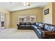 Living room with a vaulted ceiling, a large window, and a leather sofa at 9816 W Freiburg Dr # A, Littleton, CO 80127