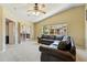 Living room with a vaulted ceiling, a large window, and a leather sofa at 9816 W Freiburg Dr # A, Littleton, CO 80127