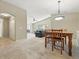 Open-concept living room and dining area features plush carpeting and ample natural light at 9816 W Freiburg Dr # A, Littleton, CO 80127
