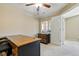 Home office with neutral walls, carpeted flooring, desk and a ceiling fan at 9816 W Freiburg Dr # A, Littleton, CO 80127