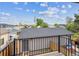 Balcony with black metal railing overlooking backyard featuring a storage shed with a gray roof at 2226 S Galapago St, Denver, CO 80223