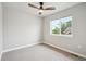 Bright bedroom with neutral walls, carpet flooring, a ceiling fan, and a large window with outdoor views at 2226 S Galapago St, Denver, CO 80223