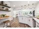 Bright and airy kitchen with modern appliances, white cabinetry, stylish pendant lights and open design to the living spaces at 2226 S Galapago St, Denver, CO 80223