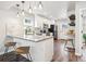 Modern kitchen with stainless steel appliances, white cabinets, quartz countertops, and stylish bar stool seating at 2226 S Galapago St, Denver, CO 80223