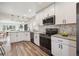 Well-appointed kitchen with stainless steel appliances, modern cabinetry, and a stylish design, open to the dining area at 2226 S Galapago St, Denver, CO 80223
