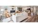 Open-concept living space featuring a modern fireplace and seamless flow to the kitchen at 2226 S Galapago St, Denver, CO 80223
