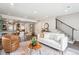 Spacious living room that features an open concept with sleek hardwood flooring, and access to the basement and kitchen at 2226 S Galapago St, Denver, CO 80223