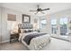Comfortable bedroom with a ceiling fan, balcony access, and neutral tones at 2226 S Galapago St, Denver, CO 80223