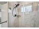 Updated shower with glass door and mosaic tile details at 2226 S Galapago St, Denver, CO 80223
