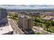 Aerial view of modern building with surrounding city landscape and river, capturing a desirable urban setting at 3575 Chestnut Pl # 702, Denver, CO 80216