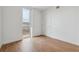 Bright bedroom featuring wood floors and a large window providing natural light at 3575 Chestnut Pl # 702, Denver, CO 80216