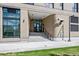 Modern building entrance featuring architectural details and well-maintained landscaping at 3575 Chestnut Pl # 702, Denver, CO 80216