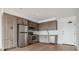Modern kitchen featuring stainless steel appliances, wood cabinets, and a stylish subway tile backsplash at 3575 Chestnut Pl # 702, Denver, CO 80216