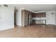 Spacious living room with wood flooring that flows into the kitchen, showcasing open-concept design at 3575 Chestnut Pl # 702, Denver, CO 80216