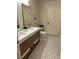 Elegant bathroom featuring double vanity with quartz countertop and modern mosaic tile floor at 1975 N Grant # 310, Denver, CO 80203