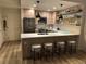 Modern kitchen with stainless steel appliances, wood cabinets and a breakfast bar with four stools at 1975 N Grant # 310, Denver, CO 80203