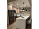 Stylish kitchen with stainless steel appliances, breakfast bar with stools, and floating shelves with décor at 1975 N Grant # 310, Denver, CO 80203