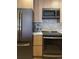 Updated kitchen featuring stainless steel refrigerator, microwave, oven, and gas cooktop at 1975 N Grant # 310, Denver, CO 80203