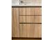 Close-up of sleek, light wood-tone kitchen cabinets with modern hardware at 1975 N Grant # 310, Denver, CO 80203