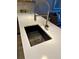 Modern kitchen sink with a sleek faucet, stainless steel basket and bright white countertop at 1975 N Grant # 310, Denver, CO 80203