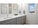 Bright bathroom featuring double sinks, modern fixtures and a sunlit window at 8408 W 52Nd Ave, Arvada, CO 80002