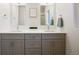 Modern bathroom with double sinks, gray cabinetry, and neutral decor at 8408 W 52Nd Ave, Arvada, CO 80002