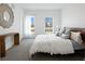 Bright bedroom featuring a bed, textured carpet, and natural light from two windows at 8408 W 52Nd Ave, Arvada, CO 80002
