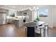 Modern dining area adjacent to the kitchen featuring stylish chairs and plenty of natural light from large windows at 8408 W 52Nd Ave, Arvada, CO 80002