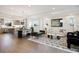 Open-concept living area showcasing modern decor with a seamless transition between kitchen, dining, and living spaces at 8408 W 52Nd Ave, Arvada, CO 80002